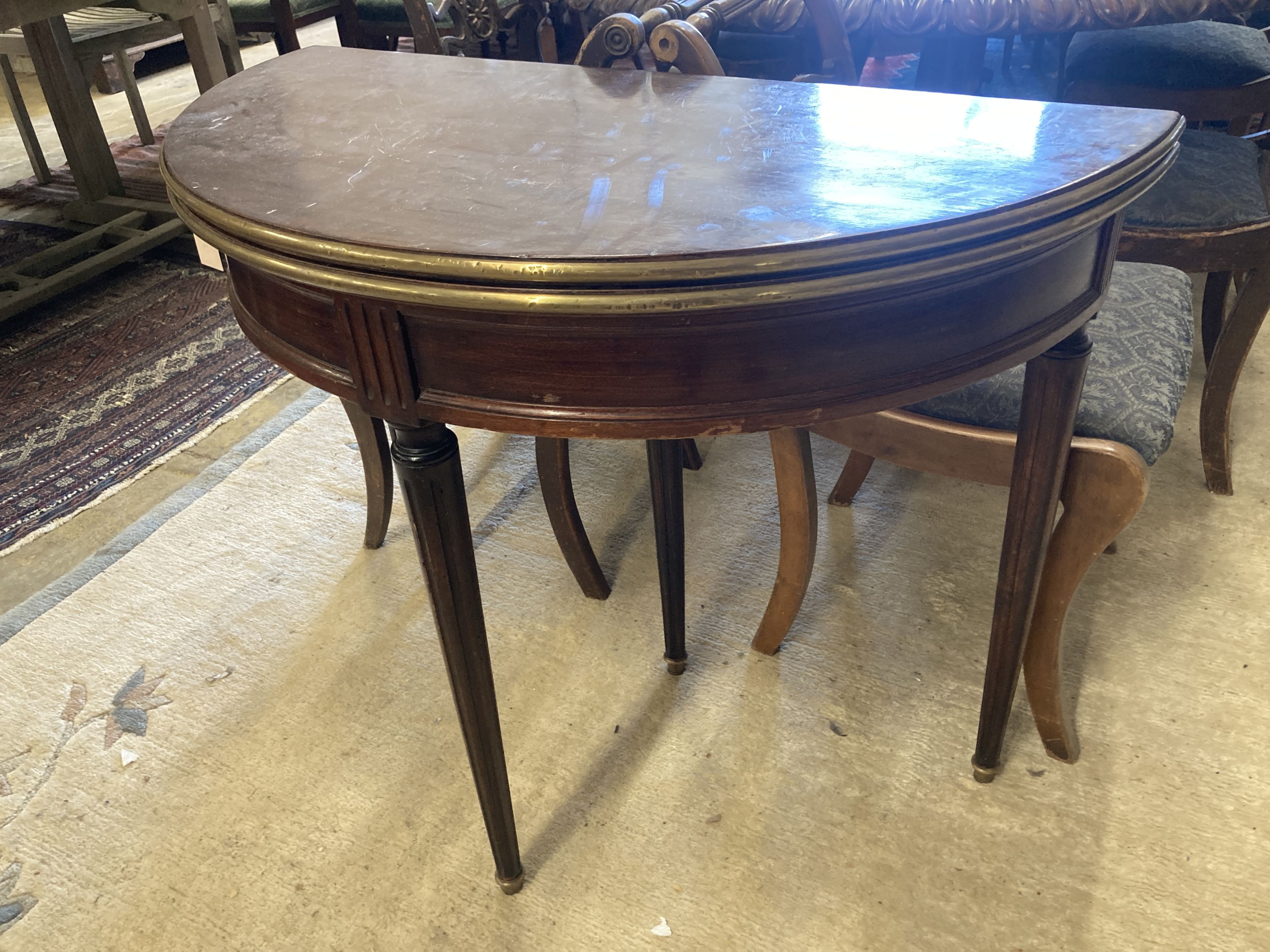 An early 20th century French brass mounted mahogany D shape folding card table, width 91cm, depth 46cm, height 75cm
